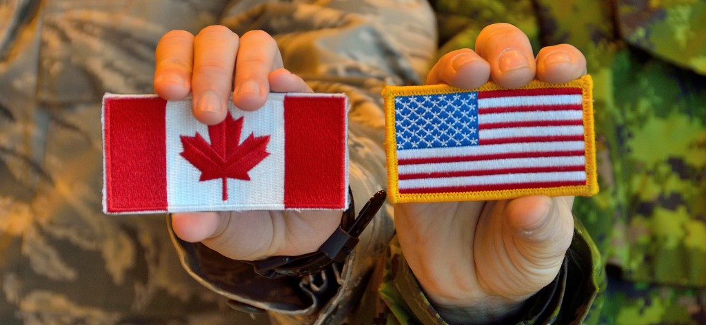 Canadian and American military members exchange their flags at 5 Wing Goose Bay, Newfoundland and Labrador during Exercise VIGILANT SHIELD 17 on October 17, 2016. 